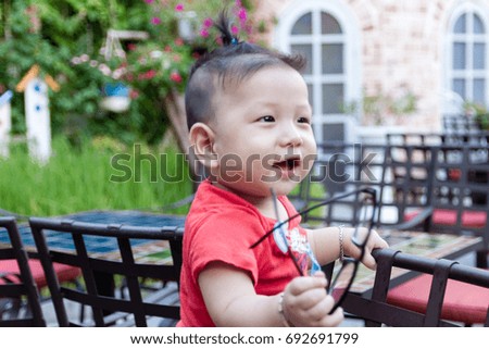 Cute Vietnamese Baby playing in the coffee shop