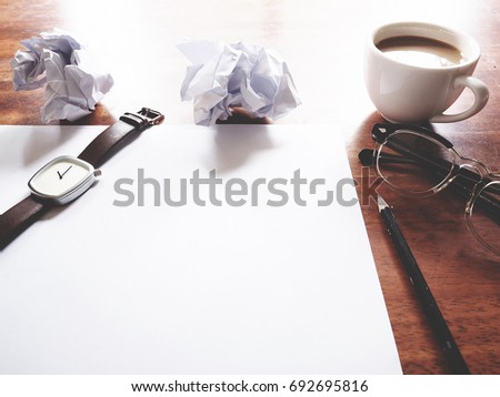 Businesses have both been successful and fail. The picture of fail work, glasses, paper, pencil, watch, a cup of coffee  and men hand gesture above wooden table.  soft tone color