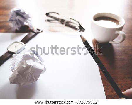 Businesses have both been successful and fail. The picture of fail work, glasses, paper, pencil, watch, a cup of coffee  and men hand gesture above wooden table.selective focus.  soft tone color