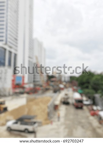 blurred image of construction workers on site and machinery on the street near building with sky.  Construction Concept.