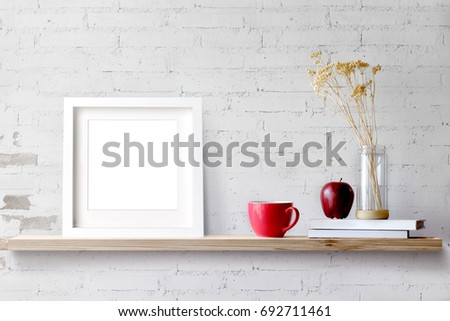 Wood shelf with blank white frame and coffee.Blank screen for products or graphic montage.
