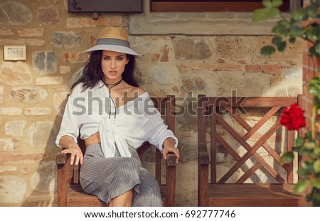 Woman resting in summer in her home garden