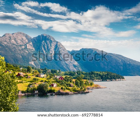 Picturesque summer view of typical Norwegian village on the shore of fjord. Traveling concept background.
Artistic style post processed photo.
