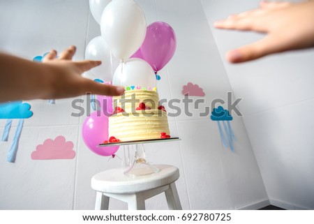 cropped shot of human hands reaching to delicious birthday cake