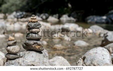balancing stones on the mountain river