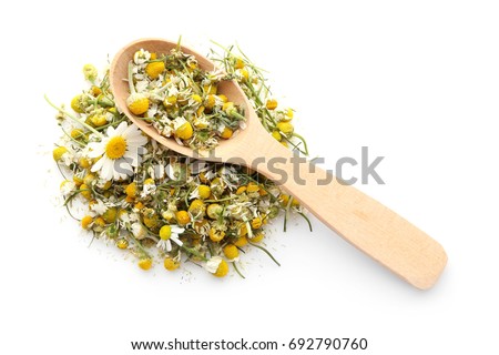 Dried chamomile flowers and wooden spoon on white background Royalty-Free Stock Photo #692790760