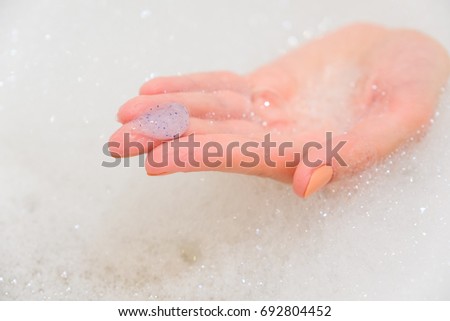 Body scrub with exfoliating particles. Selective focus. Closeup Royalty-Free Stock Photo #692804452