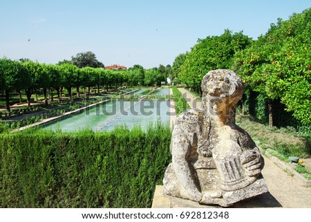 Statue and gardens with fountains of the Alcazar de los Reyes Cristianos in Cordoba, Andalusia