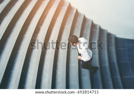 Businessman running fast upstairs Growth up Success concept Royalty-Free Stock Photo #692814715