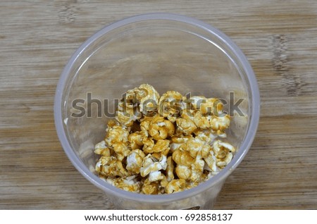 sweet caramel popcorn on top of wooden table
