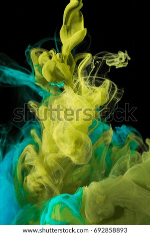 color ink drops in water with black background, macro photography 
