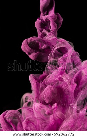 color ink drops in water with black background, macro photography 

