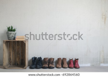 Old vintage crate and boots in front of an industrial concrete wall 2.