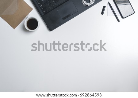 Office supplies and gadgets on a white desk background. View is from above 4.