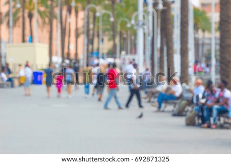 Blurred background of people around in area city park, spring and summer season.