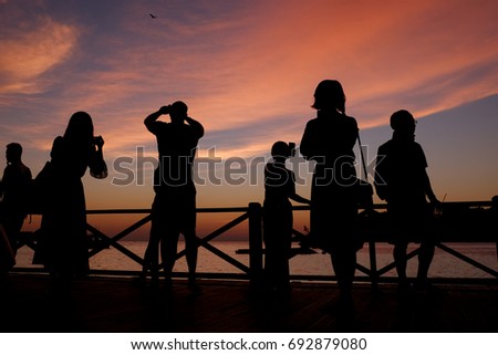 Silhouette of people taking picture at majestic sunset, Sabah, Malaysia.
