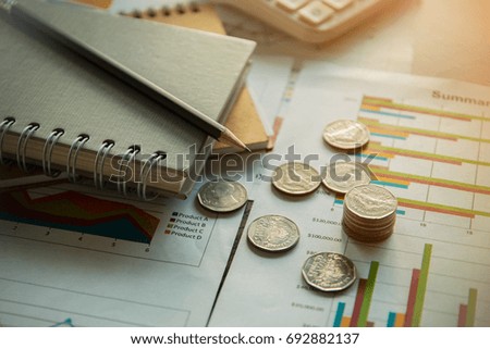 financial analyzing concept pencil and notebook with thailand coin on paperwork