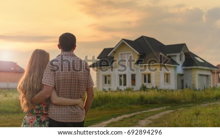 couple looking on house Royalty-Free Stock Photo #692894296