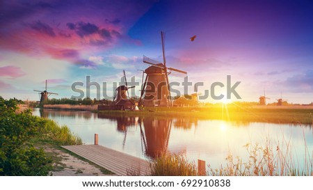 Warm and cloudy sunset on the Kinderdijk, UNESCO world heritage site, Alblasserdam, Netherlands