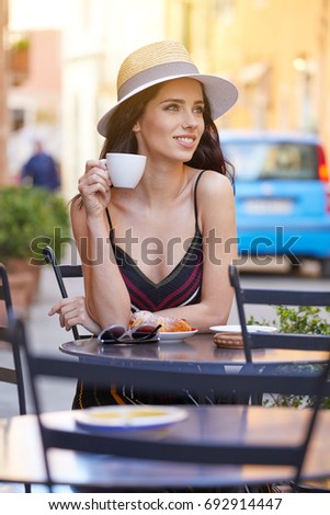 woman having italian coffee at the cafe on the street in Toscana city. Soft focus with small depth of field