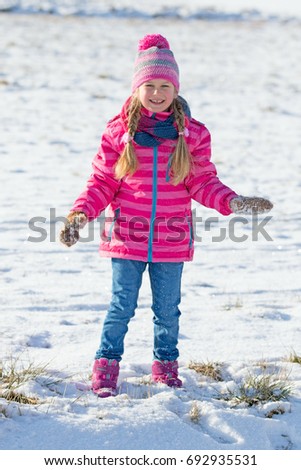 Young pretty girl enjoying the snow 