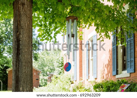 Wind chime on a tree in a backyard