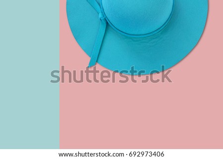 Blue summer woman hat on pastel color background, flat lay photo