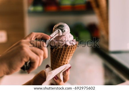 Putting ice cream to cone, summer concept