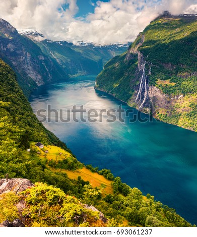 Splendid summer scene of Sunnylvsfjorden fjord, Geiranger village location, western Norway. Aerial view of famous Seven Sisters waterfalls. Beauty of nature concept background.