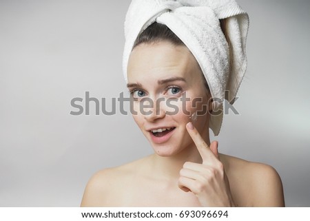 Woman pointing to acne on face