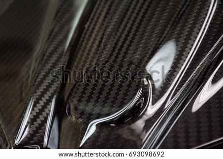 Black carbon fiber composite raw material close up background