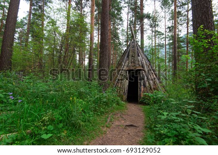 Old hovel of ancient altai people in the forest, Altai, Siberia, Russia Royalty-Free Stock Photo #693129052