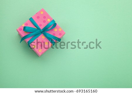 Craft paper gift box with as present for Christmas, new year, valentine day or anniversary on green background, top view, mock up