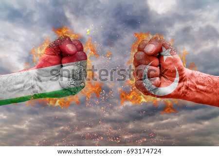 Two fist with the flag of Italy and Turkey faced at each other ready for fight