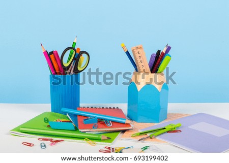 School office stationery on white table blue background