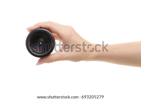 Lens on a camera in a female hand on a white background isolation