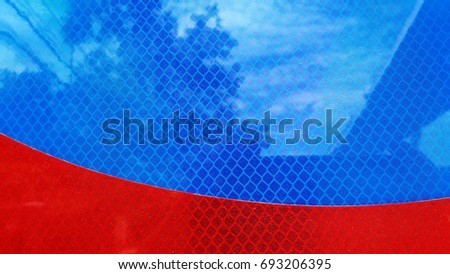 Traffic sign with red blue background,Reflected in the shadow of trees, bridges and skies.