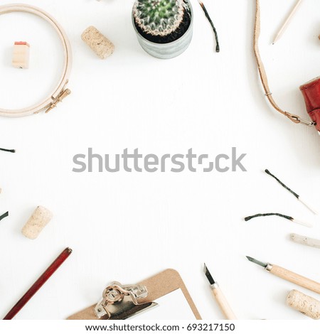 Layout with copy space made of retro camera, succulent, tools for handmade arts, clipboard on white background. Top view, flat lay hipster artist concept. 