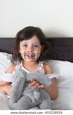 happy beautiful infant baby girl in the awake bed 