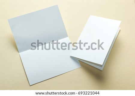 Identity design, corporate templates, company style, blank white folding paper flyer on a yellow background. mockup