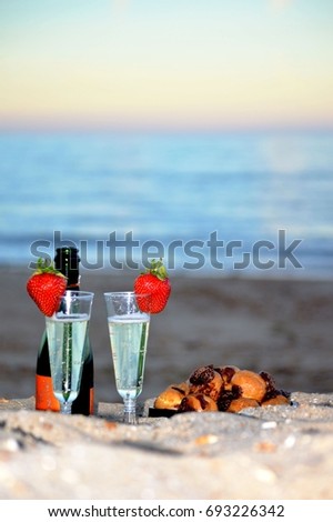 Birthday sunset at seaside, with champagne and strawberries