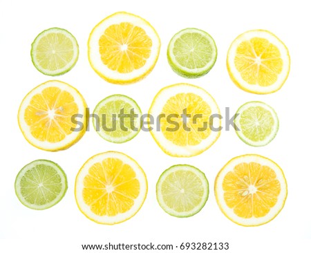 Yellow and green lemon and lime citrus slices isolated on white background, backlit through lightbox