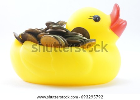 Yellow rubber ducks are carrying a large silver coin on the back.