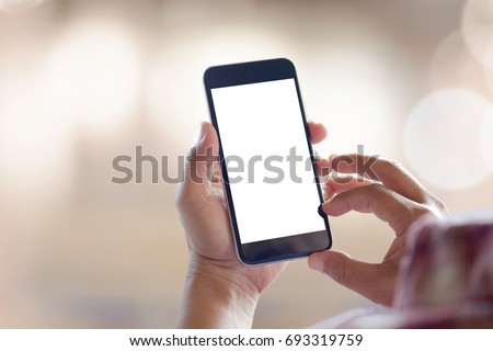 Man's hand using cellphone outdoor, Man typing text message on smart phone, Blurred background Royalty-Free Stock Photo #693319759