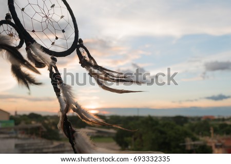 Dream Catcher on the sunset background Royalty-Free Stock Photo #693332335