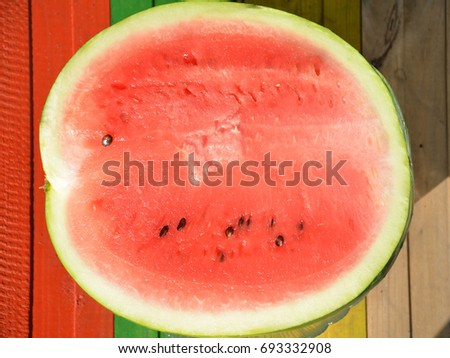 half watermelon on a multi-colored background