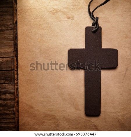 Closeup of wooden Christian cross on bible
