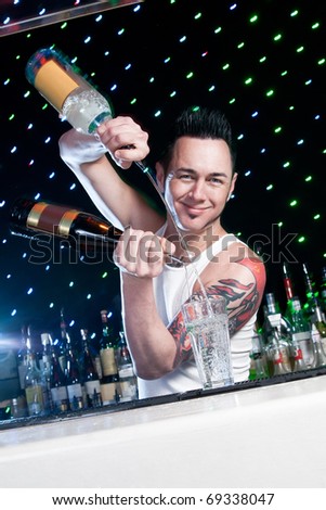 bartender is smiling and looking at the camera Royalty-Free Stock Photo #69338047