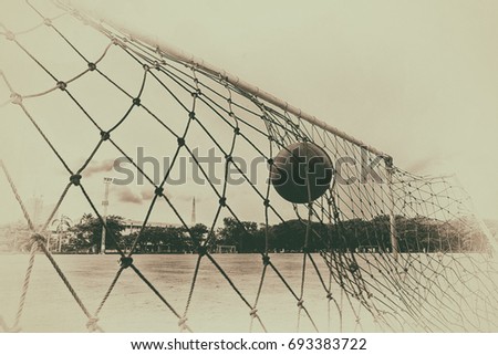pictures of the past  soccer ball in the net of the goal.