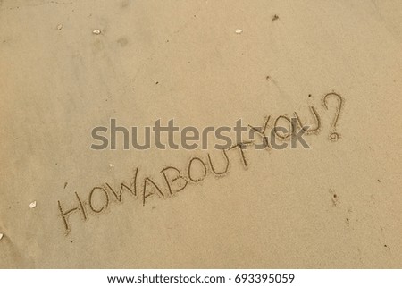 Handwriting  words "HOW ABOUT YOU?" on sand of beach.